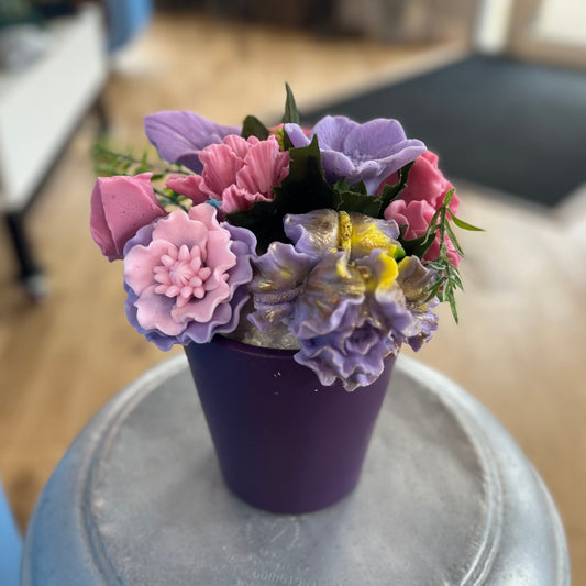 Soap flowers in purple vase