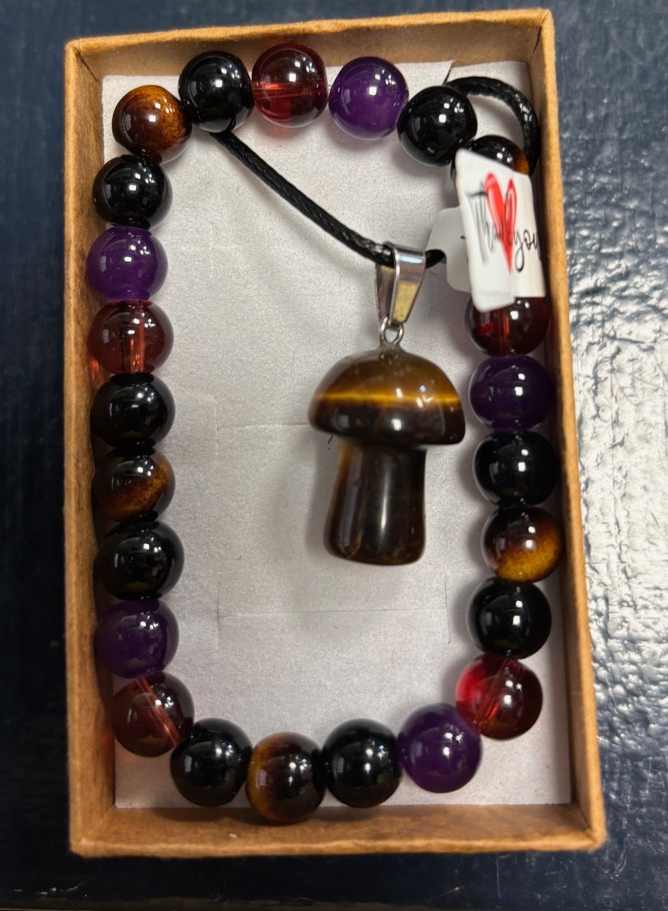 Beaded bracelet with a mushroom pendant in a box